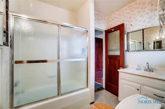 7149 Wales Rd, Northwood, OH 43619 - bathroom with wallpapered walls, vanity, bath / shower combo with glass door, and toilet