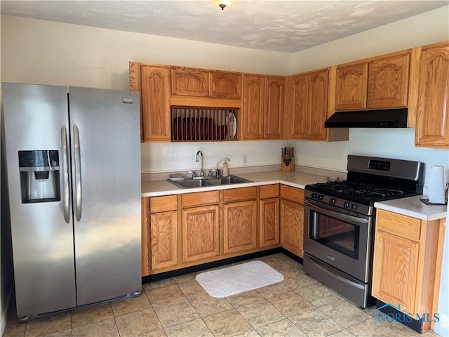 V-437 State Route 108, Napoleon, OH 43545 - kitchen featuring appliances with stainless steel finishes, under cabinet range hood, a sink, light countertops, and brown cabinets