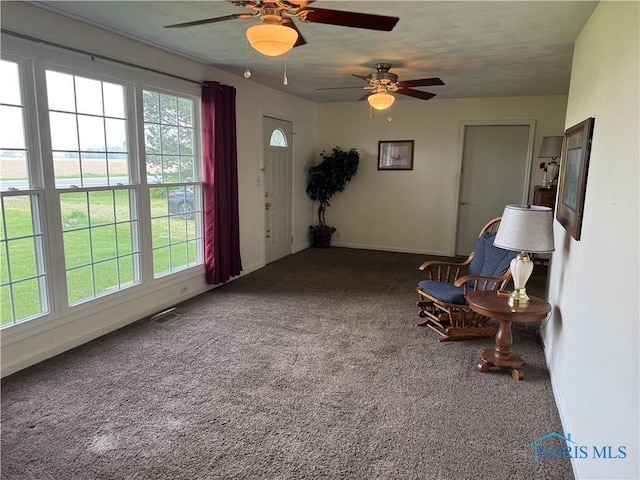 V-437 State Route 108, Napoleon, OH 43545 - living area featuring ceiling fan, carpet flooring, and baseboards