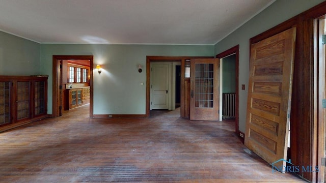 2720 Scottwood Ave, Toledo, OH 43610 - unfurnished room featuring radiator heating unit, wood finished floors, baseboards, and crown molding