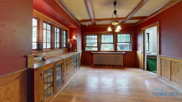 2720 Scottwood Ave, Toledo, OH 43610 - unfurnished dining area with radiator, a wainscoted wall, a chandelier, beam ceiling, and wood-type flooring