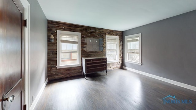 2720 Scottwood Ave, Toledo, OH 43610 - unfurnished living room featuring baseboards, wood finished floors, and an accent wall