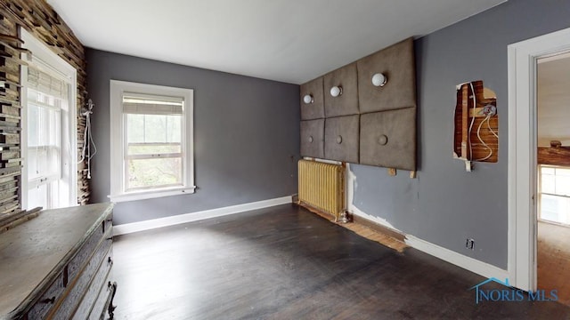 2720 Scottwood Ave, Toledo, OH 43610 - unfurnished office with radiator heating unit, baseboards, and dark wood-style floors