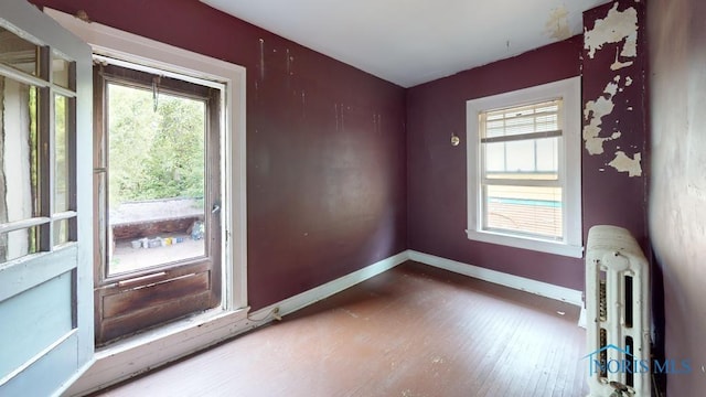 2720 Scottwood Ave, Toledo, OH 43610 - unfurnished room featuring healthy amount of natural light, baseboards, and wood finished floors