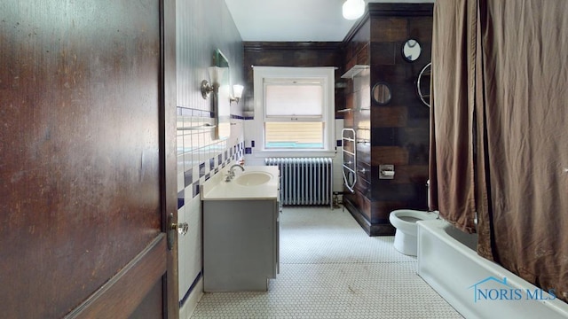2720 Scottwood Ave, Toledo, OH 43610 - bathroom with radiator, vanity, and toilet
