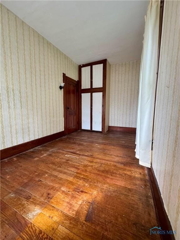 308 S Main St, Hicksville, OH 43526 - unfurnished room featuring hardwood / wood-style floors and wallpapered walls