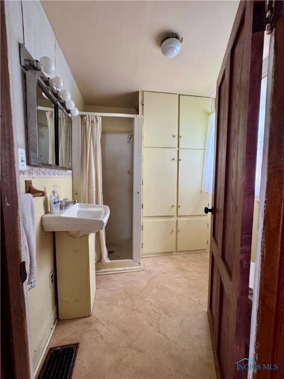 308 S Main St, Hicksville, OH 43526 - full bath featuring a stall shower and unfinished concrete floors