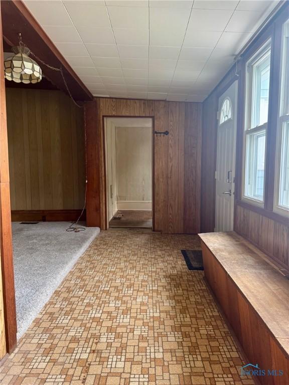 308 S Main St, Hicksville, OH 43526 - mudroom featuring wooden walls and brick patterned flooring