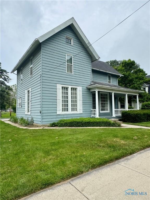 308 S Main St, Hicksville, OH 43526 - traditional-style house featuring a porch and a front yard