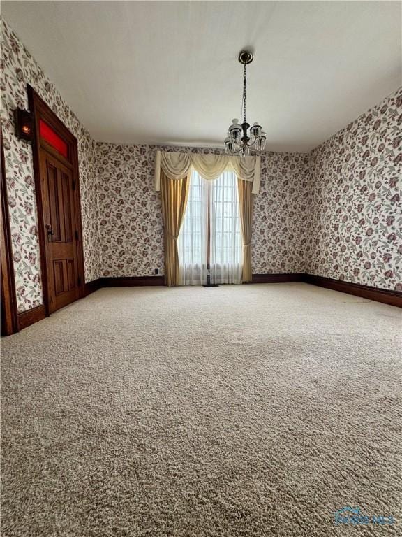 308 S Main St, Hicksville, OH 43526 - spare room featuring wallpapered walls, a chandelier, and carpet