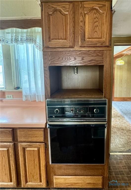 308 S Main St, Hicksville, OH 43526 - kitchen featuring black oven and brown cabinets