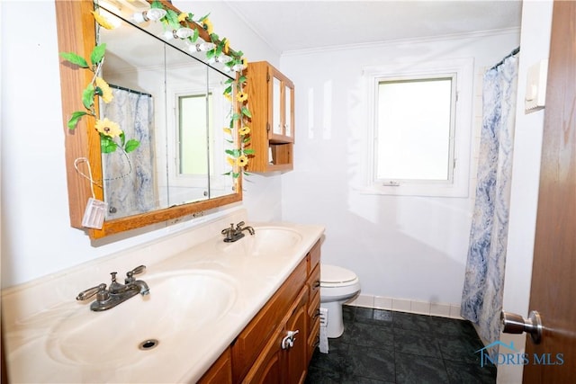 205 N Grant St, Paulding, OH 45879 - bathroom featuring double vanity, toilet, crown molding, and baseboards