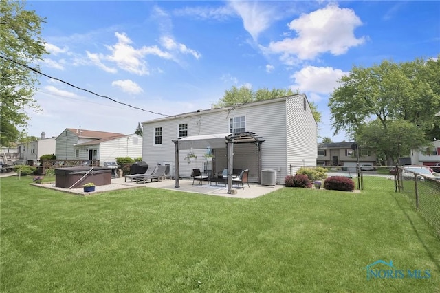 2444 Jamestown Dr, Northwood, OH 43619 - back of house with a patio, a hot tub, and central air condition unit