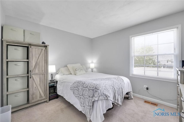 2444 Jamestown Dr, Northwood, OH 43619 - bedroom featuring light carpet, baseboards, and a barn door