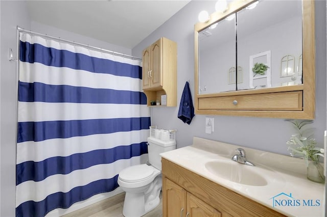 2444 Jamestown Dr, Northwood, OH 43619 - bathroom with toilet, vanity, wood finished floors, and a shower with shower curtain