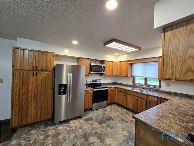 711 Circle Dr, Fostoria, OH 44830 - kitchen with appliances with stainless steel finishes, dark countertops, brown cabinetry, a sink, and recessed lighting