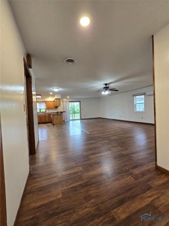 711 Circle Dr, Fostoria, OH 44830 - unfurnished living room with ceiling fan and dark wood-style floors