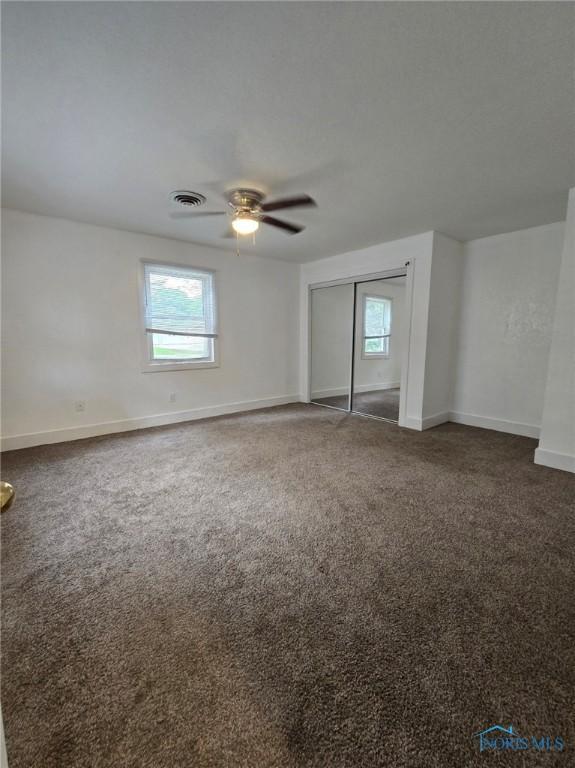 711 Circle Dr, Fostoria, OH 44830 - empty room featuring healthy amount of natural light, a ceiling fan, and carpet