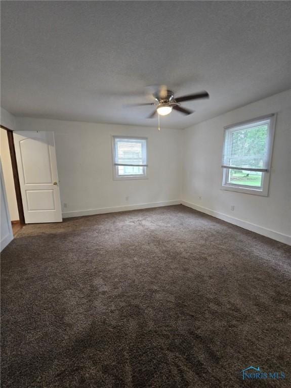 711 Circle Dr, Fostoria, OH 44830 - spare room with dark carpet and ceiling fan