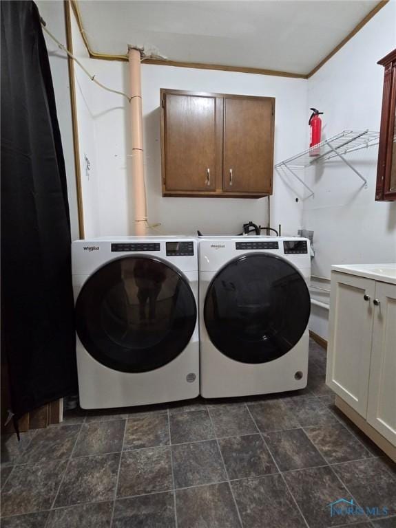 711 Circle Dr, Fostoria, OH 44830 - laundry room with separate washer and dryer, cabinet space, and stone finish floors