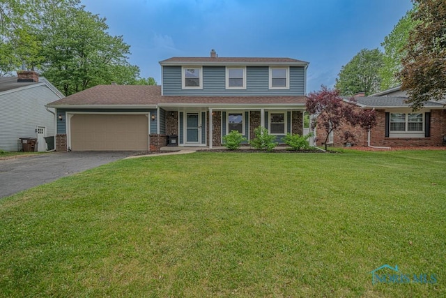3849 Sylvanwood Dr, Sylvania, OH 43560 - traditional-style house featuring an attached garage, asphalt driveway, a front lawn, brick siding, and covered porch