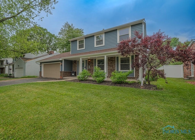 3849 Sylvanwood Dr, Sylvania, OH 43560 - traditional-style home featuring asphalt driveway, a garage, brick siding, and covered porch
