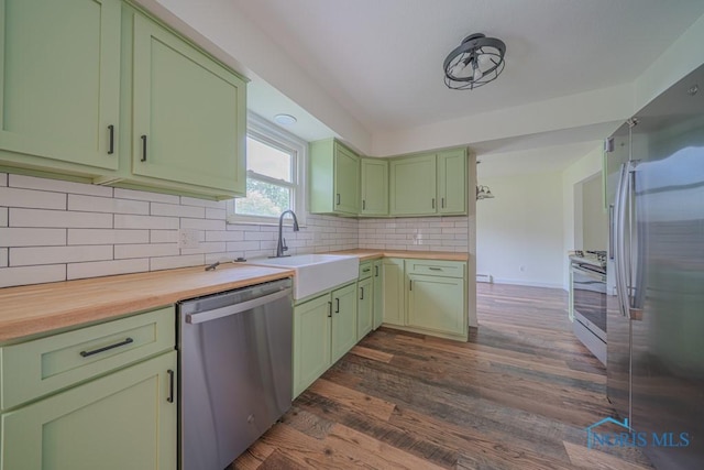 3849 Sylvanwood Dr, Sylvania, OH 43560 - kitchen with green cabinets, appliances with stainless steel finishes, butcher block counters, a sink, and dark wood-style floors