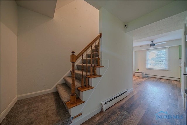 3849 Sylvanwood Dr, Sylvania, OH 43560 - stairway featuring a baseboard heating unit, ceiling fan, wood finished floors, and baseboards