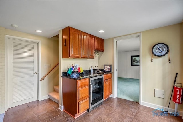 16890 W River Rd, Bowling Green, OH 43402 - kitchen with beverage cooler, dark stone counters, brown cabinetry, baseboards, and recessed lighting