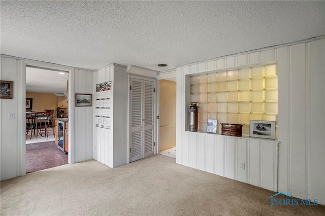 16890 W River Rd, Bowling Green, OH 43402 - unfurnished living room with carpet and a textured ceiling