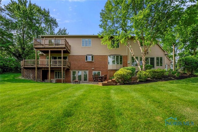 16890 W River Rd, Bowling Green, OH 43402 - back of property with a yard, a patio, a deck, and brick siding