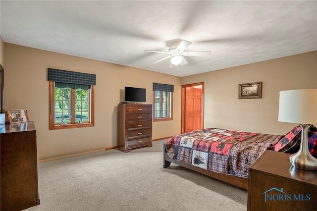 16890 W River Rd, Bowling Green, OH 43402 - carpeted bedroom featuring multiple windows, baseboards, and a ceiling fan