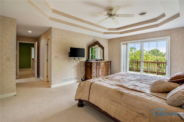 16890 W River Rd, Bowling Green, OH 43402 - carpeted bedroom featuring a tray ceiling, access to outside, baseboards, and a ceiling fan