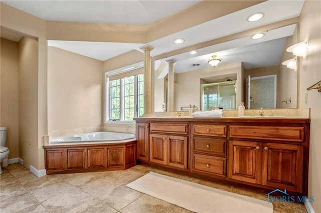 16890 W River Rd, Bowling Green, OH 43402 - bathroom with toilet, double vanity, recessed lighting, ornate columns, and a garden tub