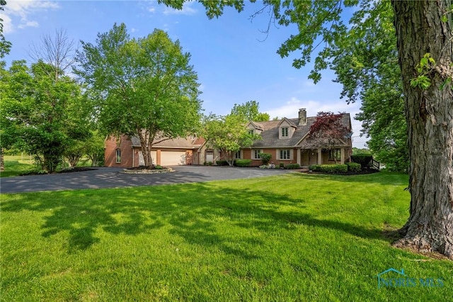 16890 W River Rd, Bowling Green, OH 43402 - cape cod home with an attached garage, driveway, a front yard, and a chimney