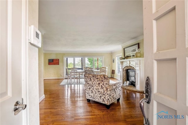 16890 W River Rd, Bowling Green, OH 43402 - living area with dark wood-style flooring, a glass covered fireplace, and baseboards