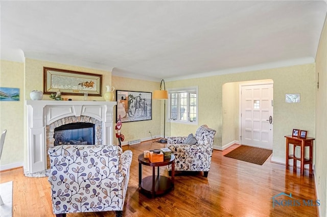 16890 W River Rd, Bowling Green, OH 43402 - living area with wood finished floors, a glass covered fireplace, and baseboards