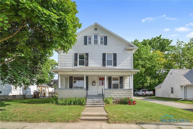 230 W S St, Fostoria, OH 44830 - view of front of house with a porch and a front yard
