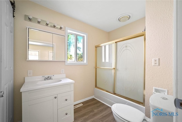 230 W S St, Fostoria, OH 44830 - full bath featuring vanity, wood finished floors, and combined bath / shower with glass door