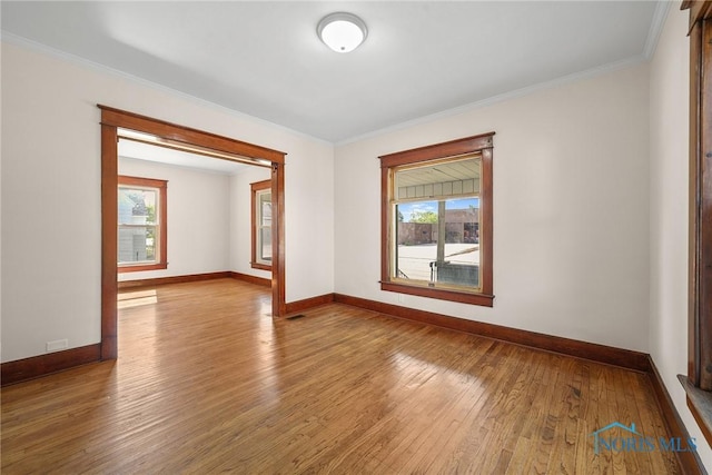 230 W S St, Fostoria, OH 44830 - unfurnished room featuring hardwood / wood-style flooring, plenty of natural light, and crown molding