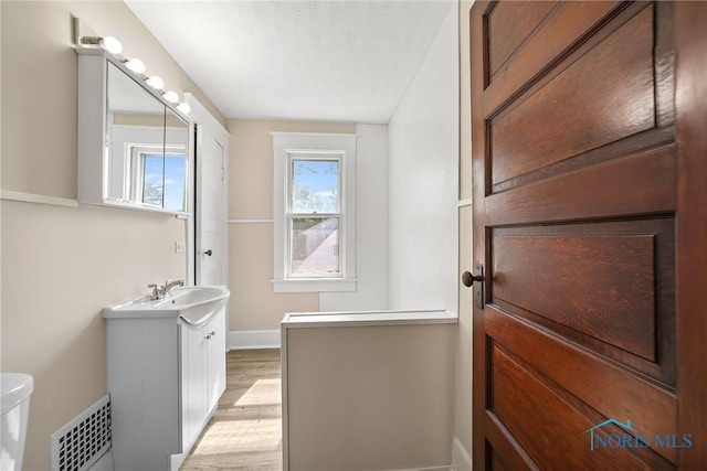 230 W S St, Fostoria, OH 44830 - bathroom featuring vanity and wood finished floors