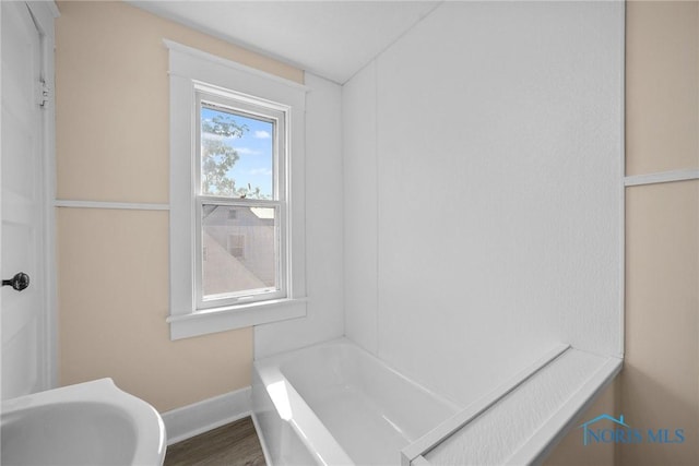 230 W S St, Fostoria, OH 44830 - bathroom featuring a tub and wood finished floors