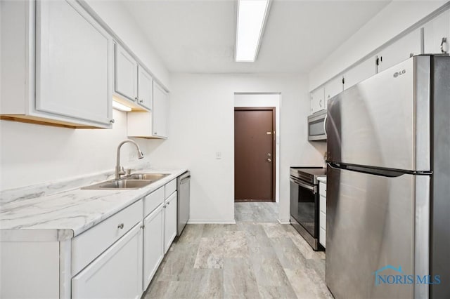 4519 W Bancroft St Unit 4, Toledo, OH 43615 - kitchen featuring stainless steel appliances, a sink, white cabinetry, and light wood-type flooring