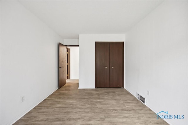 4519 W Bancroft St Unit 4, Toledo, OH 43615 - unfurnished bedroom with wood finished floors and a closet
