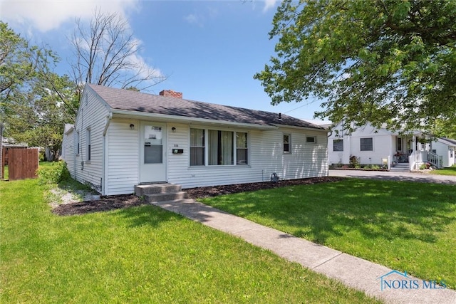 308 Edith Ave, Findlay, OH 45840 - view of front facade featuring a front yard and a chimney
