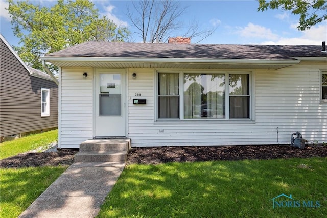 308 Edith Ave, Findlay, OH 45840 - view of front of property featuring a chimney, a front yard, and roof with shingles