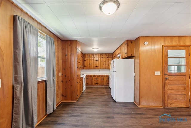 308 Edith Ave, Findlay, OH 45840 - kitchen featuring white appliances, brown cabinets, dark wood-style floors, wood walls, and light countertops