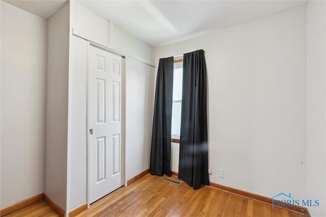 308 Edith Ave, Findlay, OH 45840 - unfurnished bedroom featuring light wood-style flooring, baseboards, and a closet
