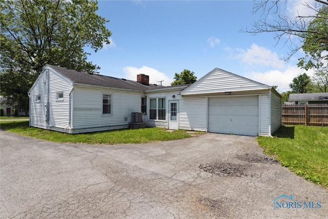 308 Edith Ave, Findlay, OH 45840 - single story home featuring a chimney, driveway, an attached garage, and cooling unit