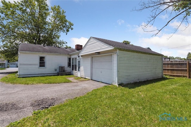 308 Edith Ave, Findlay, OH 45840 - garage with central air condition unit and asphalt driveway